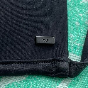 Y-3 Sleek Black Swimwear Top. Also great under transparent shirts.